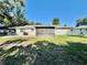 A spacious backyard offers ample green space, a screened-in porch, and endless possibilities for outdoor enjoyment at 4128 Palo Alto Dr, Lakeland, FL 33813