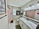 Bright bathroom with white cabinets, modern fixtures, a shower/tub combo, and a stylish mirror at 4128 Palo Alto Dr, Lakeland, FL 33813