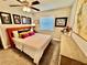 Bright bedroom features a colorful bed, gray carpet, and tasteful wall art, all illuminated by a ceiling fan at 4128 Palo Alto Dr, Lakeland, FL 33813