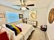 Cozy bedroom features a ceiling fan, neutral walls, carpeted floors, and decor at 4128 Palo Alto Dr, Lakeland, FL 33813