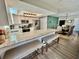 Open kitchen featuring granite countertops, stainless steel appliances and breakfast bar with bench seating at 4128 Palo Alto Dr, Lakeland, FL 33813