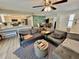 Open concept living room flows into dining and kitchen, featuring modern decor, hardwood floors, and natural light at 4128 Palo Alto Dr, Lakeland, FL 33813
