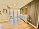 Well-lit living room with hardwood floors, a decorative wall, and ample natural light from large windows at 4128 Palo Alto Dr, Lakeland, FL 33813