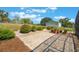 Landscaped backyard with decorative brick-paved areas with an accent of rocks surrounded by green plants at 21551 Lake Seneca Rd, Eustis, FL 32736
