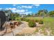 Garden area featuring potted plants and shrubs, complemented by gravel paths and a well-maintained lawn at 21551 Lake Seneca Rd, Eustis, FL 32736