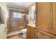 A bathroom featuring a glass door shower, with decorative fixtures and vanity sink at 21551 Lake Seneca Rd, Eustis, FL 32736