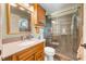 Bathroom with a granite vanity, a large mirror, and a custom glass shower at 21551 Lake Seneca Rd, Eustis, FL 32736