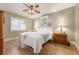Relaxing bedroom featuring a ceiling fan, natural light, and simple elegant decor at 21551 Lake Seneca Rd, Eustis, FL 32736