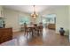 Charming dining room with classic furnishings, natural light, and seamless access to the living room at 21551 Lake Seneca Rd, Eustis, FL 32736