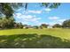 Expansive lawn surrounds this single-story home with a detached garage and ample outdoor space at 21551 Lake Seneca Rd, Eustis, FL 32736
