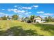 Exterior view of the house and driveway showcasing landscaping, lawn, and fencing at 21551 Lake Seneca Rd, Eustis, FL 32736