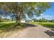 Wide exterior view of the house with a front yard, driveway, and mature landscaping at 21551 Lake Seneca Rd, Eustis, FL 32736