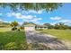 Charming single-story home with a well-manicured lawn and long driveway at 21551 Lake Seneca Rd, Eustis, FL 32736