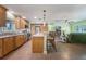 Inviting kitchen featuring a center island with seating, modern appliances and adjacent to the living area at 21551 Lake Seneca Rd, Eustis, FL 32736