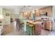 Well-lit kitchen showcasing bar seating, stainless steel appliances, and a functional layout at 21551 Lake Seneca Rd, Eustis, FL 32736