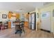 Kitchen with stainless steel appliances, wooden cabinets, and a dining table at 21551 Lake Seneca Rd, Eustis, FL 32736