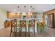 Well-equipped kitchen with wooden cabinetry, stainless steel appliances, and a breakfast bar with stylish seating at 21551 Lake Seneca Rd, Eustis, FL 32736