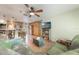 Open-concept living room with a kitchen view, comfortable seating, and a mounted television for entertainment at 21551 Lake Seneca Rd, Eustis, FL 32736