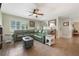 Spacious living room with neutral walls, tile flooring, and a large sofa for comfortable seating at 21551 Lake Seneca Rd, Eustis, FL 32736