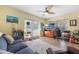 Well-lit room with french doors, ceiling fan, modern decor, and comfortable seating at 21551 Lake Seneca Rd, Eustis, FL 32736