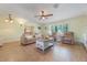 Comfortable living room with a large window, neutral tones, and tile flooring at 21551 Lake Seneca Rd, Eustis, FL 32736