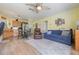 Cozy living room with a blue sofa and an adjacent kitchen and dining area at 21551 Lake Seneca Rd, Eustis, FL 32736
