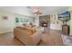 Cozy living room with a stone fireplace, built-in shelving, and natural light from the window at 21551 Lake Seneca Rd, Eustis, FL 32736
