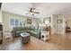 Bright living room showcasing tile floors, a large sofa, and plenty of space for relaxation and entertainment at 21551 Lake Seneca Rd, Eustis, FL 32736