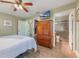 Main bedroom featuring a closet, TV, and an en-suite bathroom with a glass-enclosed shower at 21551 Lake Seneca Rd, Eustis, FL 32736