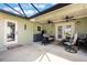 Enclosed patio with two ceiling fans, furniture and outdoor view at 21551 Lake Seneca Rd, Eustis, FL 32736