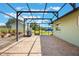 Open patio with black metal frame overlooking the lush yard and distant barn at 21551 Lake Seneca Rd, Eustis, FL 32736