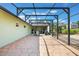 Stone patio with black metal frame leading to outdoor view of the yard and a blue truck at 21551 Lake Seneca Rd, Eustis, FL 32736