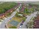 Aerial view of the community featuring a swimming pool, townhomes, and a basketball court at 5935 Tivoli Gardens Blvd, Orlando, FL 32829