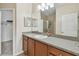 Functional bathroom with vanity and sink, complemented by a well-lit mirror at 5935 Tivoli Gardens Blvd, Orlando, FL 32829