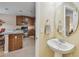 Charming half bathroom features a pedestal sink and is conveniently located near the kitchen at 5935 Tivoli Gardens Blvd, Orlando, FL 32829
