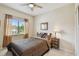Cozy bedroom featuring a ceiling fan and natural light from the window at 5935 Tivoli Gardens Blvd, Orlando, FL 32829