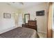 Bedroom with neutral color palette, wood dresser, and mounted flat screen tv at 5935 Tivoli Gardens Blvd, Orlando, FL 32829