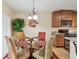 Cozy dining area features a glass table with seating for four, and an attractive decorative lighting fixture at 5935 Tivoli Gardens Blvd, Orlando, FL 32829