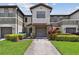 Charming townhome featuring a well-maintained lawn and inviting front entrance with two-car garage at 5935 Tivoli Gardens Blvd, Orlando, FL 32829