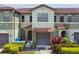 Charming townhome featuring a tile roof, front garden, and an attached garage at 5935 Tivoli Gardens Blvd, Orlando, FL 32829