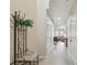 Bright hallway featuring tile floors, neutral walls, and a glimpse into the living area at 5935 Tivoli Gardens Blvd, Orlando, FL 32829