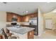 Spacious kitchen featuring stainless steel appliances, wood cabinets, and granite countertops at 5935 Tivoli Gardens Blvd, Orlando, FL 32829