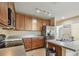 Open kitchen layout showcasing wood cabinets, stainless steel appliances, and countertop space at 5935 Tivoli Gardens Blvd, Orlando, FL 32829