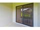 Covered patio with a screen door and view of a building at 5935 Tivoli Gardens Blvd, Orlando, FL 32829