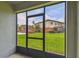 Screened-in patio offers a view of a well-maintained grassy area and nearby buildings at 5935 Tivoli Gardens Blvd, Orlando, FL 32829