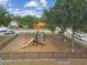 Community playground with slide, set in a fenced enclosure with trees and open space at 5935 Tivoli Gardens Blvd, Orlando, FL 32829
