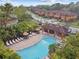 Community pool featuring lounge chairs and umbrellas, nestled among lush landscaping at 5935 Tivoli Gardens Blvd, Orlando, FL 32829