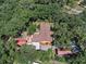 Aerial view of a home surrounded by a dense forest, showcasing its secluded location at 1625 Itchepackesassa Dr, Lakeland, FL 33810