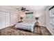 Bright bedroom features a ceiling fan, two windows, and wood look flooring at 1625 Itchepackesassa Dr, Lakeland, FL 33810