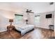 Bright bedroom features a ceiling fan, two windows, and wood look flooring at 1625 Itchepackesassa Dr, Lakeland, FL 33810